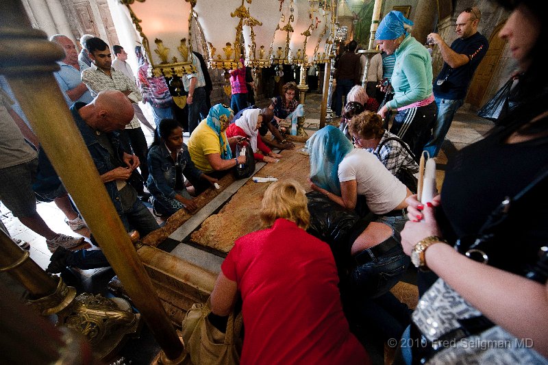 20100410_110926 D3.jpg - Stone of Unction. Where Jesus was annointed.  It was very important to people to  touch this stone.  People bring important objects and pictures and place on top